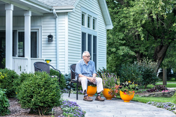 istock Curious Senior Man Sitting Outside Home Watching 1430211919