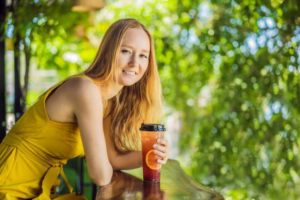 istock Drinking Spritz at summer terrace. Elegant woman drinking iced summer cocktail 1430212557