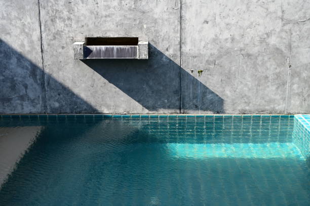 istock faucet of swimming pool on cement wall, construction industry 1430214941