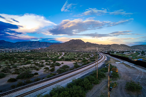 Train tracks alongside Puerto de Anapra town at the border between USA and Mexico - drone view