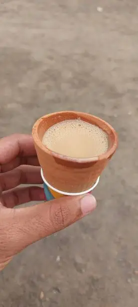 Holding tandoori chai cup with blur background