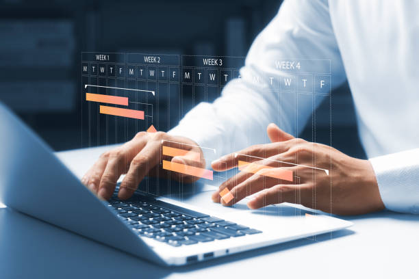 istock Planning and Implementation, Business people use laptop computers to manage work projects and update tasks. Work progress, efficient scheduling. 1430226617