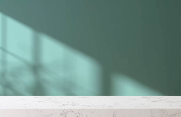 White marble tabletop or countertop in modern and minimal turquoise green blue wall room with sunlight and tree shadow from window at home White marble tabletop or countertop in modern and minimal turquoise green blue wall room with sunlight and tree shadow from window at home for household and personal product display blue light room stock pictures, royalty-free photos & images