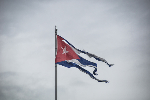 Cuban flag waving on a green background. Horizontal composition with copy space.