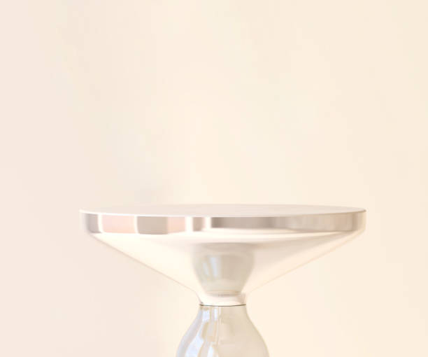 istock Modern and minimal glossy smooth iridescent round podium side table in sunlight on cream white wall background 1430233489