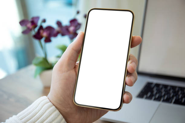istock Man hands holding golden phone with isolated screen in office 1430237379