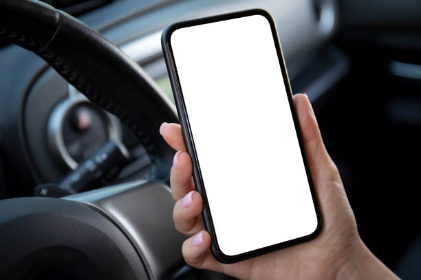istock female hand holding phone with isolated screen in car interior 1430238404