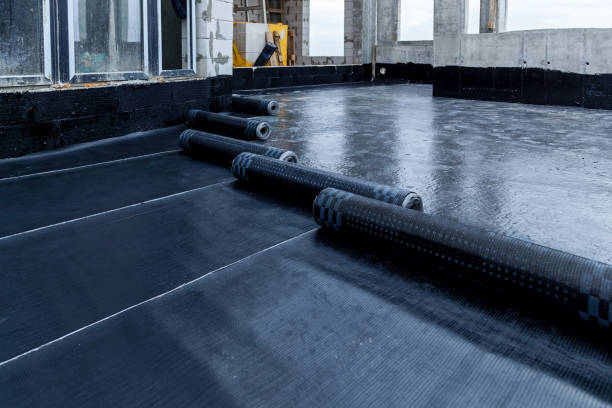 roof laying and installation Laying and installation of roofing, bituminous waterproofing of an apartment building. Rolled roofing waterproofing of concrete slabs of stylobate. Heating and melting of bituminous roofing material. tar stock pictures, royalty-free photos & images