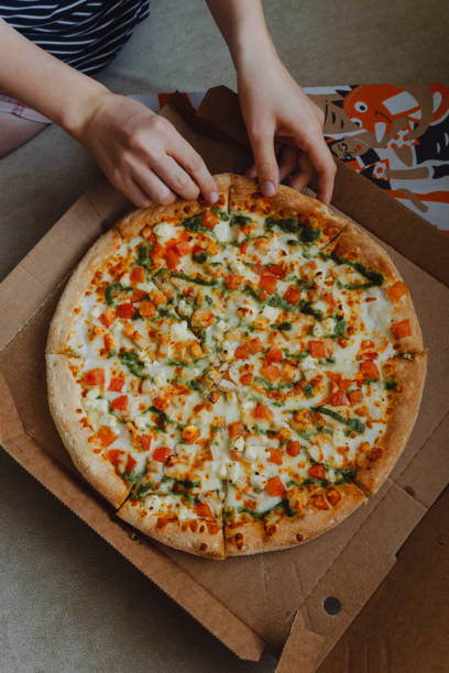 istock person eating pizza 1430239878