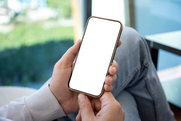 istock man in jeans holding  hands gold phone with isolated screen 1430242121