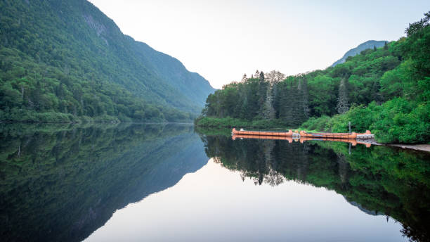 istock Reflection of mountains and forest in a tranquil lake 1430246020