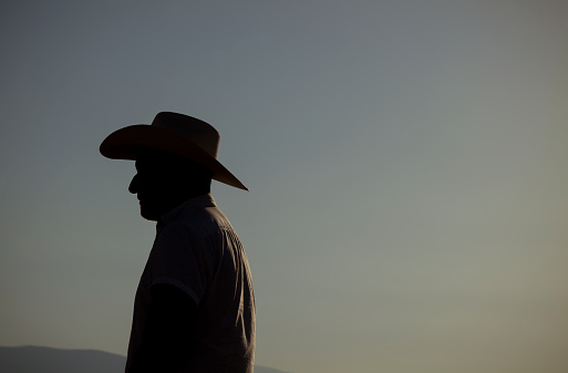 Side view of adult man in cowboy hat in desert. Almeria, Spain