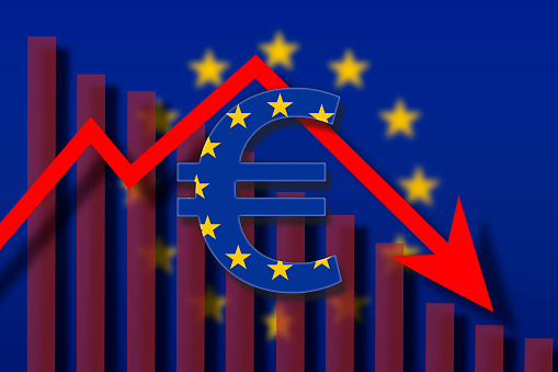 European Union flag paint over on Euro symbol. European currency crash concept .