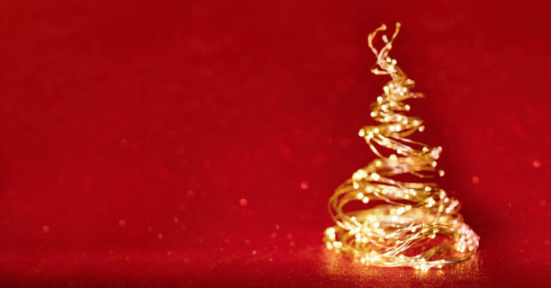 istock Defocused christmas tree from the xmas lights on red background 1430252411