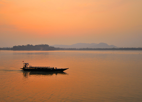 A boat sailing in river Brahmaputra in Guwahati during sunset.