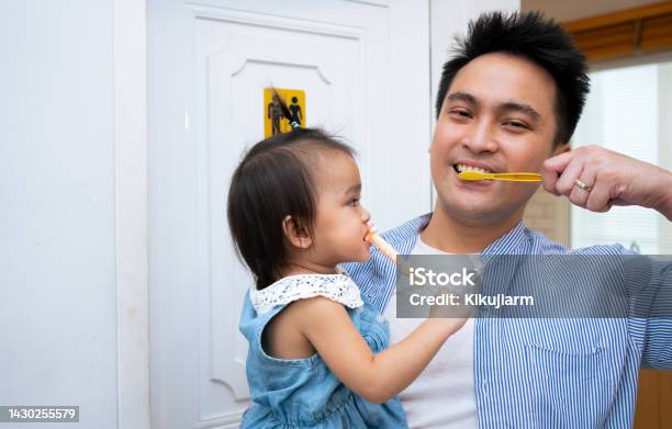 Father Teaching Baby Boy Brushing Teeth The Concept Of Oral Hygiene From The First Tooth Stock Photo - Download Image Now