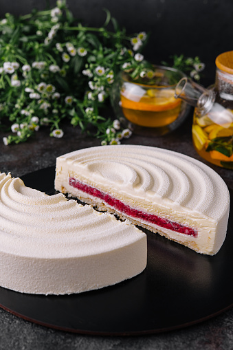 Elegant French mousse cake covered with white chocolate velour