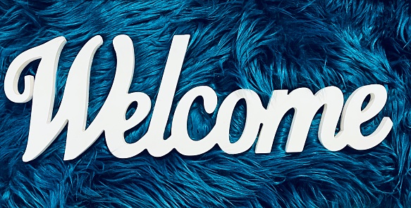 Text welcome on dark green feathered background
