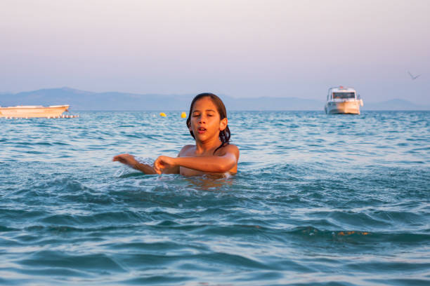 istock Boy having fun in sea 1430265740
