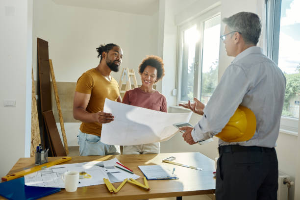 istock Black couple talking to male architect during home renovation process. 1430267292
