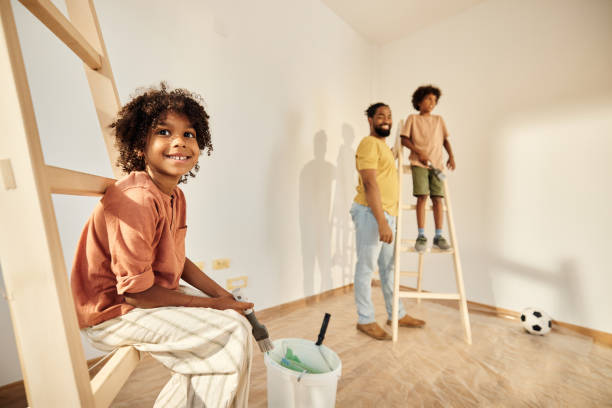 istock Happy black girl relaxing on ladders during home renovation process. 1430267319
