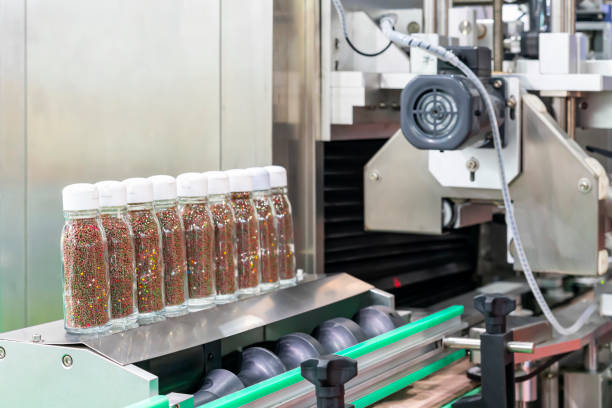 istock Small grain like product in clear bottle glass are placed arrange row on automatic solid filling and capped machine in manufacturing process 1430270398
