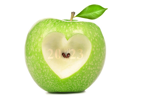 Red apple with a heart symbol isolated on white