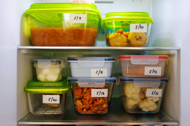 food leftovers packaged in boxes inside a home fridge - packaged food imagens e fotografias de stock