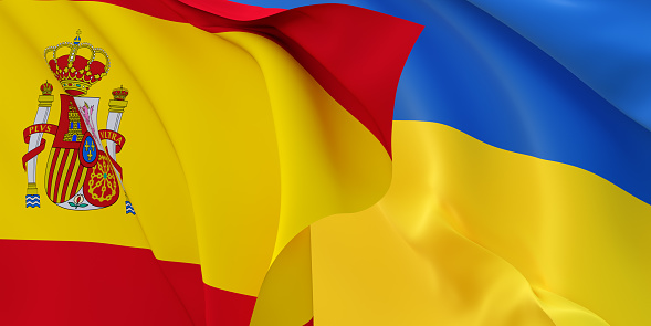 Spanish and Ukrainian flags flying in the wind. Spain stand with Ukraine. 3D rendered image.