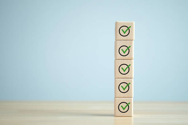 istock Checklist, Task list, Survey and assessment. Quality Control. Goals achievement and business success. Green check mark icon on wooden blocks. 1430273025