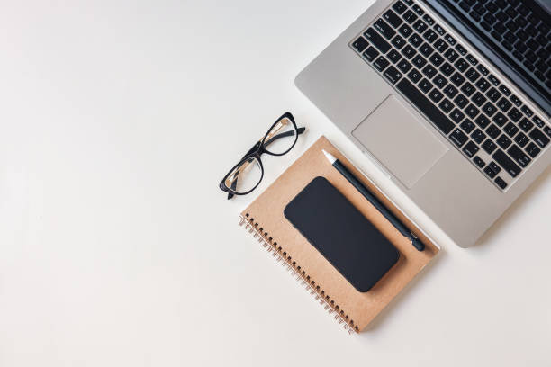 istock Laptop, phone, notepad and glasses, top view 1430274492