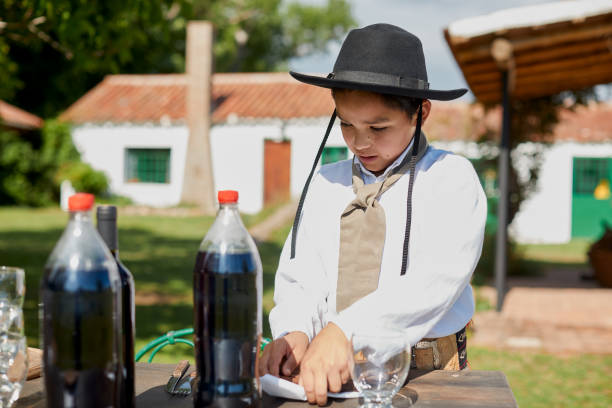 istock Argentine gaucho boy preparing table for afternoon picnic 1430278636