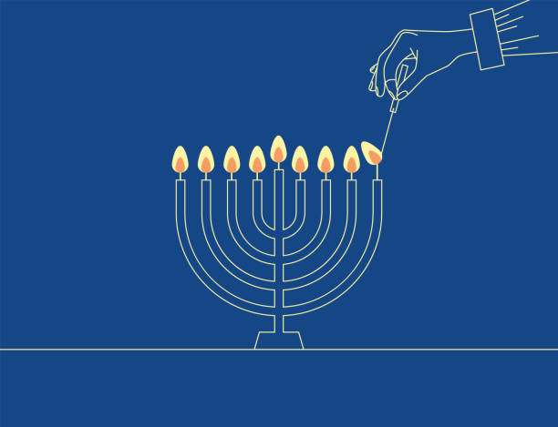ręczne świece świecznikowe na metalowej chanuce menora na powierzchni na niebieskim tle. człowiek zapala świece w menorze. żydówka świętuje chanukę - hanukkah stock illustrations