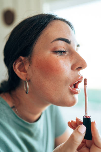 istock woman using make up products at home 1430280370