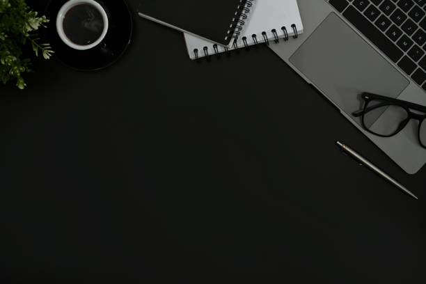 istock Laptop computer, coffee cup and potted plant on black background. Copy space for your text. 1430284356