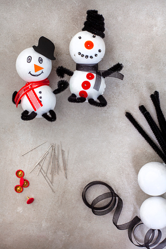Kids Christmas craft of snow man made with polystyrene balls, pipe cleaners and other bits and bobs