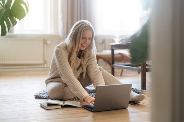 istock Woman sittin gon the floor, using her laptop 1430290187
