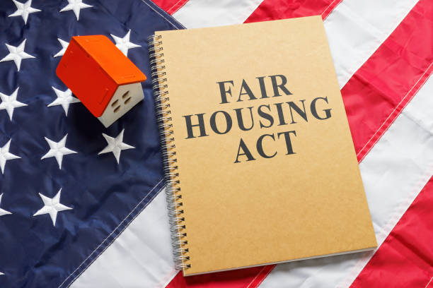 Fair housing act near tiny house on a flag. Fair housing act near tiny house on flag. housing difficulties stock pictures, royalty-free photos & images