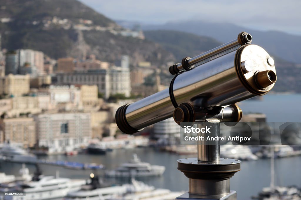 Morning view of the Principality of Monaco Monaco, Monaco - 02.10.2022: Morning view of the Principality of Monaco from the Prince's palace, with a telescope in the foreground, partly out of focus Architecture Stock Photo