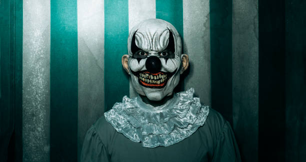 istock creepy evil clown in the old circus, banner 1430292014