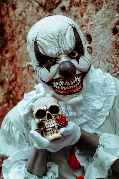 istock scary evil clown with a skull in his hands 1430292133