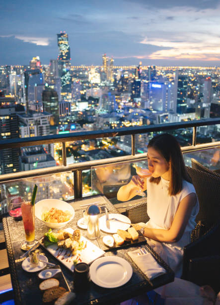 Asian beautiful adult using mobile smartphone capturing Luxury dinner celebration