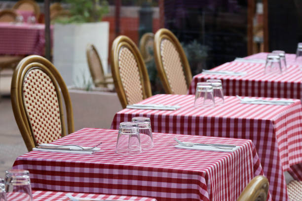 istock Tables on a restaurant terrace with a typical red checkered tablecloth 1430293325