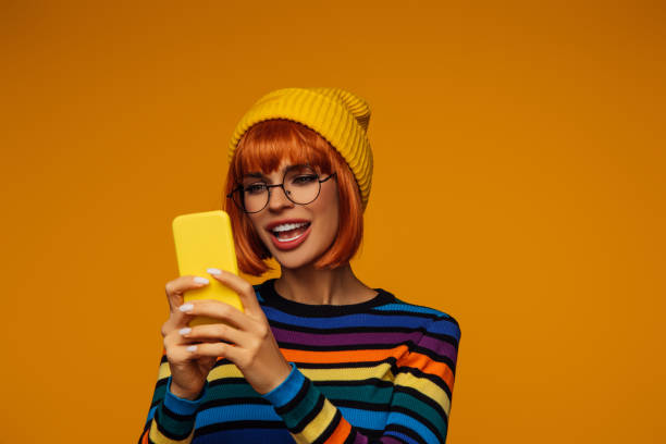 istock Beautiful emotional woman with bright make-up using phone 1430294694