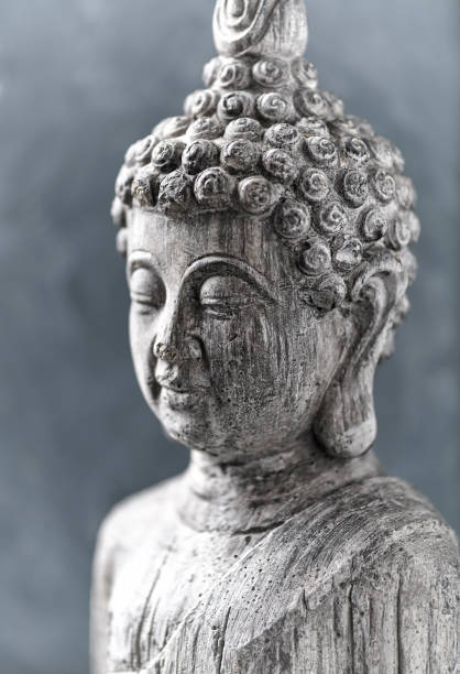 istock Meditating Buddha Statue on bright background. Close up. 1430297240