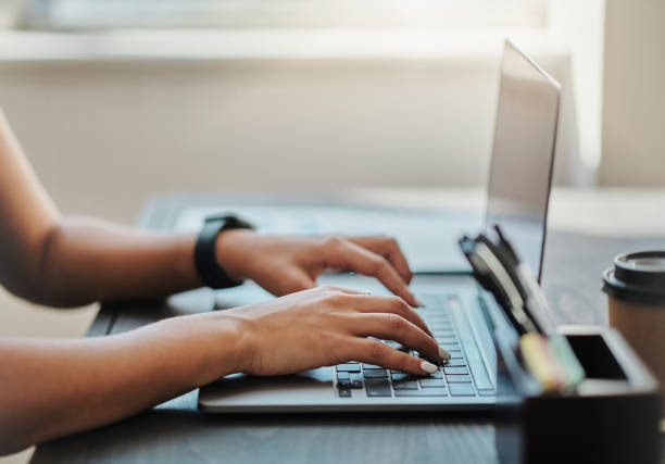 istock Laptop, table and hand typing in office, home or online study woman with technology for learning. Girl, computer and hands work on computer on desk for social media, research or digital marketing 1430297923