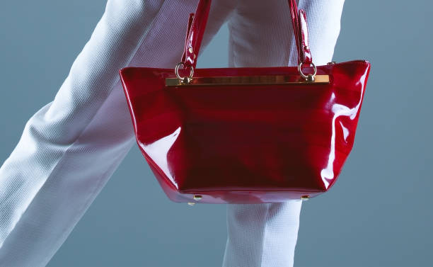 istock Stylish red patent leather bag on a blue background 1430300436