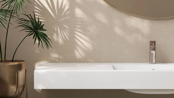 직사각형 세면대와 햇빛과 창문의 잎 그림자에 열대 식물이있는 흰색 석영 욕실 화장대의 현대적이고 최소한의 디자인 - 허영 뉴스 사진 이미지
