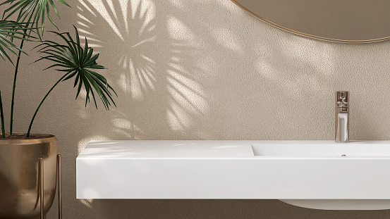Modern and minimal design of white quartz bathroom vanity with rectangle washbasin and tropical plant in sunlight and leaf shadow from window on beige wall for personal care and toiletries product display
