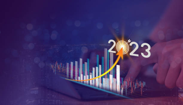 Businessman touch the glow light Data digital marketing graph and chart with arrow up.positive indicators in 2023, businessman calculates financial data for long-term investments. stock photo